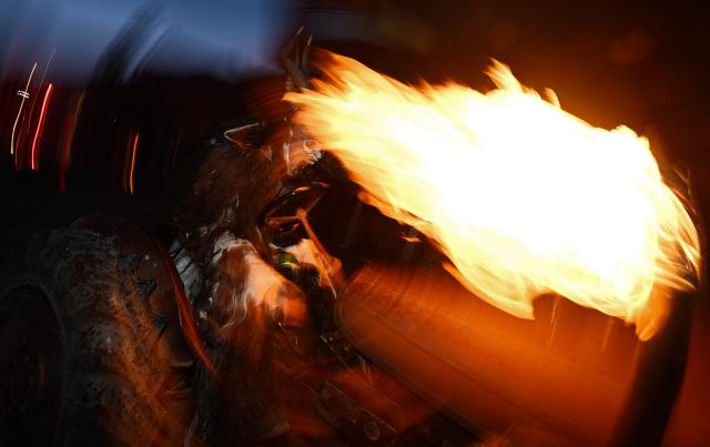 A reveller dressed as traditional folkloric figure "Krampus", rides a quad as they take part in the traditional parade during the "Night of Hell" in Lana, northern Italy, on November 22, 2025. An old tradition that takes place in the Alps of Tirol northern Italy, the traditional Krampus creature (half-goat, half-demon figure) punishes people who misbehaved during Christmas season. (Photo by Stefano RELLANDINI / AFP)
