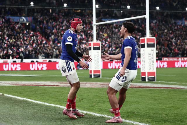 France's wing #11 Louis Bielle-Biarrey (L) celebrates with France's centre #23 Kalvin Gourgues after scoring a try  during the Autumn Nations Series international rugby union test match between France and Australia at the Stade de France in Saint-Denis, north of Paris, on November 22, 2025. (Photo by Thibaud MORITZ / AFP)