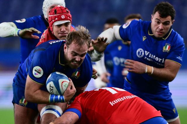 Italy's lock Niccolo Cannone (L) is tackled during the Autumn Nations Series international rugby union test match between Italy and Chile at Stadio Luigi Ferraris stadium in Genoa, on November 22, 2025. (Photo by MARCO BERTORELLO / AFP)