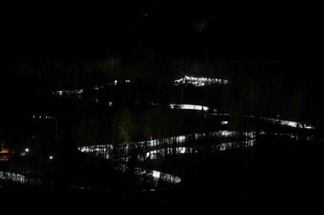 This photograph shows a general view of the Cortina Sliding Centre, which will host bobsleigh, skeleton and luge competitions ahead the Olympic Winter Games Milano Cortina 2026, on November 22, 2025. (Photo by Stefano RELLANDINI / AFP)