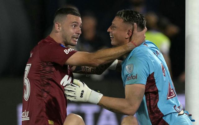 Lanus' midfielder #23 Ramiro Carrera (L) and goalkeeper #26 Nahuel Losada (R) celebrate after winning the penalty shootut of Copa Sudamericana final football match between Argentina's Lanus and Brazil's Atletico Mineiro at the Defensores del Chaco stadium in Asuncion on November 22, 2025. (Photo by JUAN MABROMATA / AFP)
