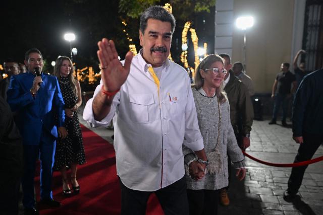 Venezuela's President Nicolas Maduro waves as he arrives for the projection of a biographical series at the National Theatre of Venezuela in Caracas on November 22, 2025. (Photo by Juan BARRETO / AFP)
