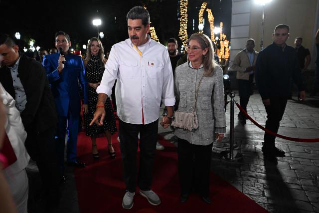 Venezuela's President Nicolas Maduro and his wife Cilia Flores arrive for the projection of a biographical series at the National Theatre of Venezuela in Caracas on November 22, 2025. (Photo by Juan BARRETO / AFP)