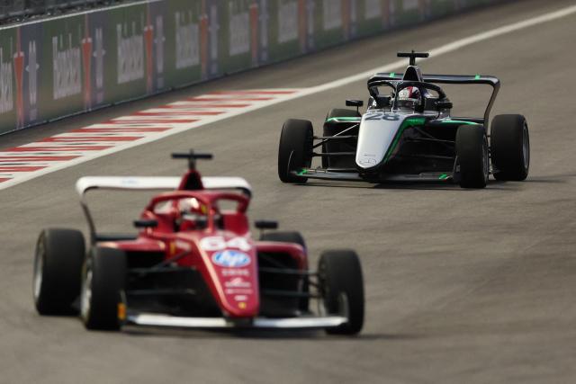 (L/R) Dutch-Belgian driver Maya Weug (64) and French driver Doriane Pin (28) race during the F1 Academy race at the Las Vega Strip Circuit in Las Vegas, Nevada, on November 22, 2025. (Photo by Patrick T. Fallon / AFP)