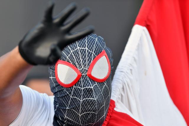 A supporter dressed in a Spider-Man costume of Honduran presidential candidate and media personality Salvador Nasralla, of the right-wing Liberal Party (PL), waves during his campaign closing rally in Tegucigalpa on November 22, 2025. Hondurans will head to the polls on November 30 to elect a president, 128 members of the National Congress, 298 mayors, and 20 representatives to the Central American Parliament. (Photo by Orlando SIERRA / AFP)