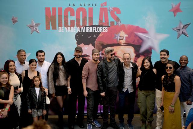 The cast of "Nicolas: from Yare to Miraflores", the Venezuelan President Nicolas Maduro's biographical series, pose for a photo at the National Theatre of Venezuela in Caracas on November 22, 2025. (Photo by Juan BARRETO / AFP)