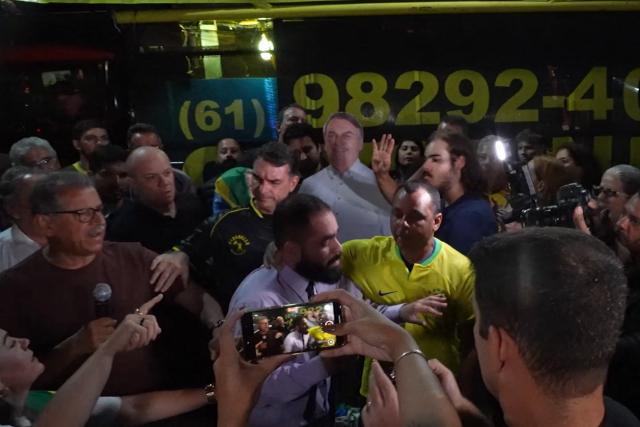 This screen grab taken from AFPTV video footage shows supporters of former Brazil’s President (2019–2023) Jair Bolsonaro clashing with an opponent next to Brazilian Senator Flavio Bolsonaro, son of the former president, during a vigil for his health and freedom in Brasilia on November 22, 2025. Ex-President Jair Bolsonaro -who in September had been sentenced to 27 years in prison over a botched coup bid but has yet to begin serving his term- was taken from house arrest into police custody as he is considered a flight risk according to a Supreme Court ruling. (Photo by Jose OSORIO / AFPTV / AFP)