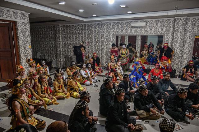 Artists gather before taking part in a wayang orang performance, at the Cak Durasim Art Building in Surabaya, East Java province on November 22, 2025. Wayang orang, also known as wayang wong or "human puppet" is a traditional Javanese and Balinese dance theatrical performance where human actors play the roles of puppets to tell storis from Hindu epics such as the Ramayana and Mahabharata. (Photo by Juni KRISWANTO / AFP)