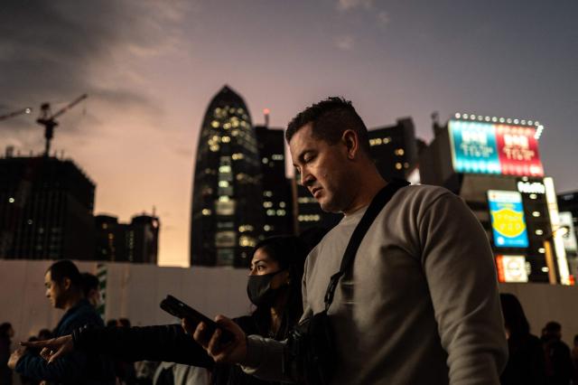 Tourists walking along a street of Tokyo's Shinjuku district on November 22, 2025. (Photo by Philip FONG / AFP)