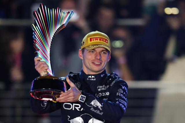 Red Bull Racing's Dutch driver Max Verstappen holds up the trophy on the podium after winning the Las Vegas Formula One Grand Prix at the Las Vegas Strip Circuit in Las Vegas, Nevada, on November 22, 2025. (Photo by Patrick T. Fallon / AFP)