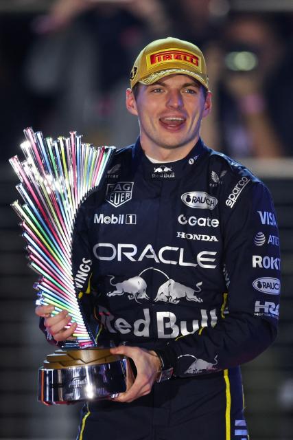 Red Bull Racing's Dutch driver Max Verstappen holds up the trophy on the podium after winning the Las Vegas Formula One Grand Prix at the Las Vegas Strip Circuit in Las Vegas, Nevada, on November 22, 2025. (Photo by Patrick T. Fallon / AFP)