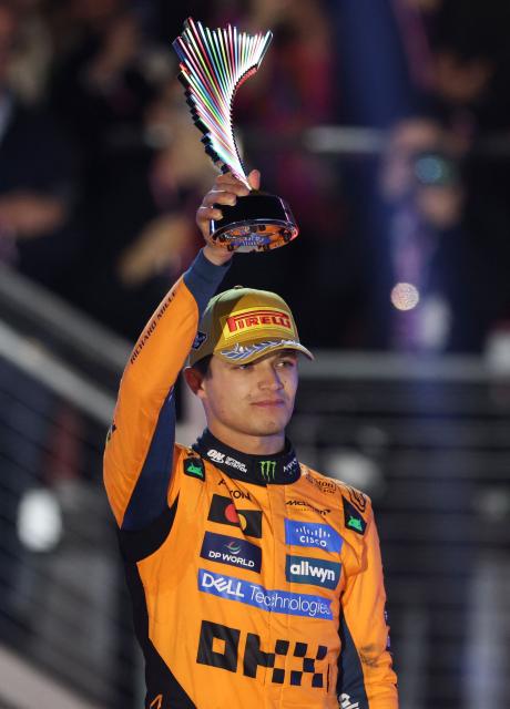 Second place finisher McLaren's British driver Lando Norris holds his trophy on the podium after the Las Vegas Formula One Grand Prix at the Las Vegas Strip Circuit in Las Vegas, Nevada, on November 22, 2025. Formula One world champion Max Verstappen produced a masterful drive to win the Las Vegas Grand Prix on Saturday as McLaren's Lando Norris finished second to edge closer to a maiden drivers' title.
Red Bull ace Verstappen pounced on a slip by pole-sitter Norris on the first turn of Sin City's street circuit to grab the lead and controlled the race thereafter to claim the 69th Grand Prix win of his career, finishing more than 20 seconds clear. (Photo by Patrick T. Fallon / AFP)