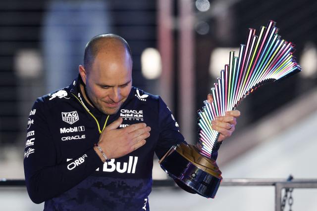 Head of Red Bull Racing Gianpiero Lambiase holds the Constructor's trophy as he celebrates on the podium after the Las Vegas Formula One Grand Prix at the Las Vegas Strip Circuit in Las Vegas, Nevada, on November 22, 2025. (Photo by Patrick T. Fallon / AFP)