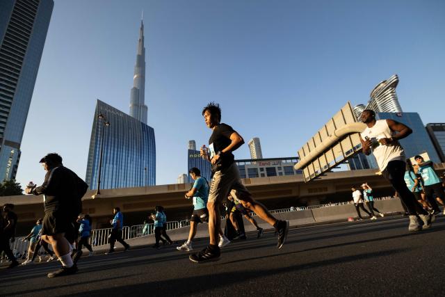 Runners take part in the "Dubai Run 2025" as part of the 9th Edition of Dubai Fitness Challenge, in Dubai on November 23, 2025. (Photo by FADEL SENNA / AFP)