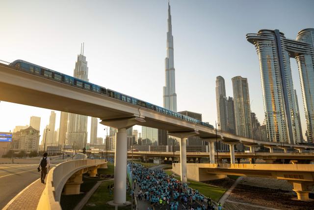 Runners take part in the "Dubai Run 2025" as part of the 9th Edition of Dubai Fitness Challenge, in Dubai on November 23, 2025. (Photo by FADEL SENNA / AFP)