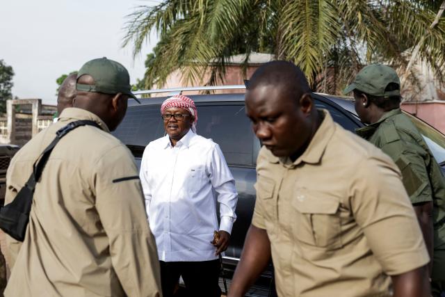 Guinea-Bissau's President and presidential candidate Umaro Sissoco Embalo (C) arrives to cast his ballot flanked by security personnel at the Gabu Maternal and Child Center polling station in Gabu on November 23, 2025 during Guinea-Bissau's presidential and legislative elections. (Photo by Patrick MEINHARDT / AFP)