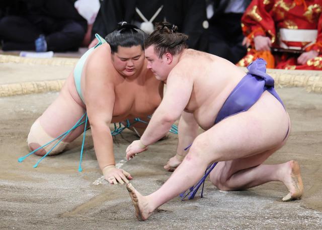 Ukrainian sumo wrestler Danylo Yavhusishyn (R), also known by his Japanese ring name Aonishiki Arata, fights against Kotozakura during the Grand Sumo Tournament in Fukuoka on November 23, 2025. (Photo by JIJI PRESS / AFP) / Japan OUT