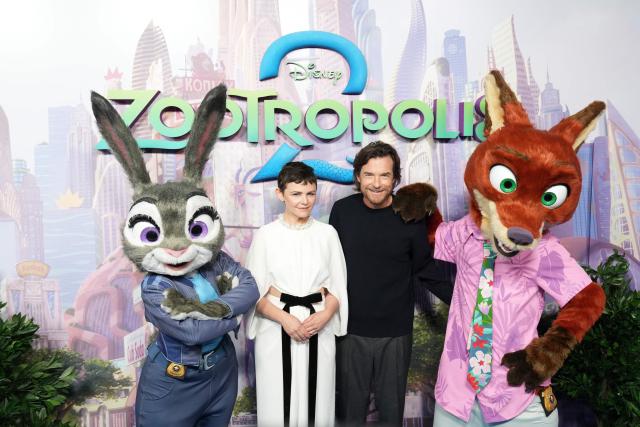 US actors Ginnifer Goodwin (L) and Jason Bateman (R) pose with characters from the film on the red carpet on arrival for the UK Premiere of "Zootropolis 2"  in London on November 23, 2025. (Photo by CARLOS JASSO / AFP)