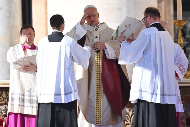 Pope Leo XIV does the cross sign as he leads the mass of Jubilee of Choirs and Choral Society at St Peter's Square in The Vatican, on November 23, 2025. (Photo by Andreas SOLARO / AFP)