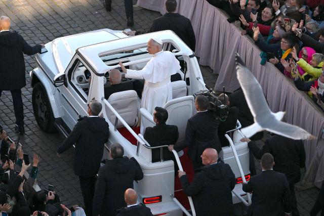 Pope Leo XIV (C) waves to the crowd from the popemobile as he leaves at the end of the mass of Jubilee of Choirs and Choral Society at St. Peter's Square in The Vatican on November 23, 2025. (Photo by Andreas SOLARO / AFP)