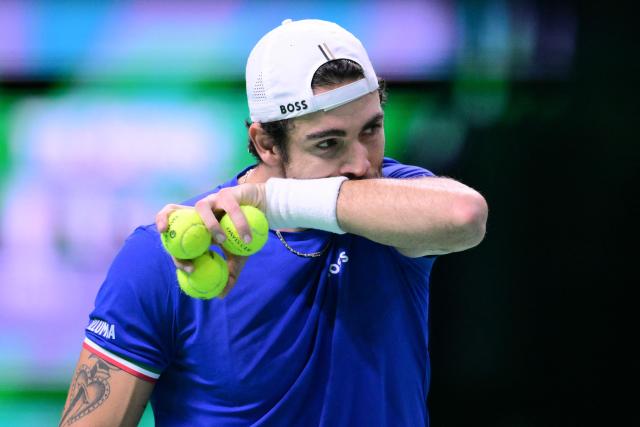 Italy's Matteo Berrettini wipes his face as he plays against Spain's Pablo Carreno Busta during their 2025 Davis Cup men's single final tennis match at the Super Tennis Arena in Bologna, northen Italy, on November 23, 2025. (Photo by Tiziana FABI / AFP)