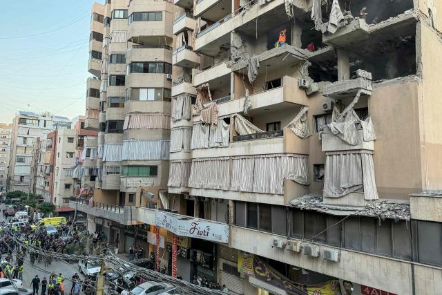 Workers clean the rubble from the site of an Israeli air attack that targeted a residential building in Beirut’s southern Haret Hreik neighborhood on November 23, 2025. Israeli prime minister gave the orders for a strike in Beirut on November 23, 2025, which targeted militant group Hezbollah's "chief of staff". Lebanon's health ministry reported at least one person killed in the strike, and 21 people wounded, calling it a "preliminary toll". (Photo by Ibrahim AMRO / AFP)