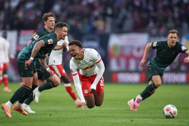 Leipzig's German midfielder #20 Assan Ouedraogo and Bremen's Austrian defender #32 Marco Friedl vie for the ball during the German first division Bundesliga football match between RB Leipzig and Werder Bremen in Leipzig on November 23, 2025. (Photo by Ronny HARTMANN / AFP) / DFL REGULATIONS PROHIBIT ANY USE OF PHOTOGRAPHS AS IMAGE SEQUENCES AND/OR QUASI-VIDEO