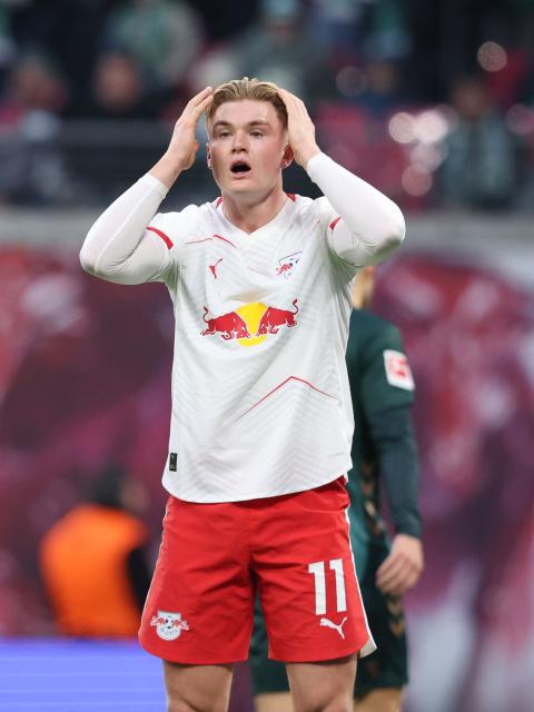 Leipzig's Danish forward #11 Conrad Harder reacts during the German first division Bundesliga football match between RB Leipzig and Werder Bremen in Leipzig on November 23, 2025. (Photo by Ronny HARTMANN / AFP) / DFL REGULATIONS PROHIBIT ANY USE OF PHOTOGRAPHS AS IMAGE SEQUENCES AND/OR QUASI-VIDEO