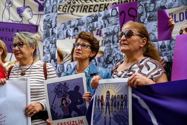 Protesters hold placards and shout slogans during a protest ahead of the International Day for the Elimination of Violence Against Women, in Istanbul, on November 23, 2025. (Photo by Yasin AKGUL / AFP)