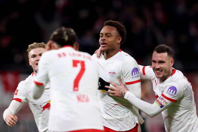 Leipzig's German midfielder #20 Assan Ouedraogo (2R) celebrates scoring his team's first goal with teammates during the German first division Bundesliga football match between RB Leipzig and Werder Bremen in Leipzig on November 23, 2025. (Photo by Ronny HARTMANN / AFP) / DFL REGULATIONS PROHIBIT ANY USE OF PHOTOGRAPHS AS IMAGE SEQUENCES AND/OR QUASI-VIDEO