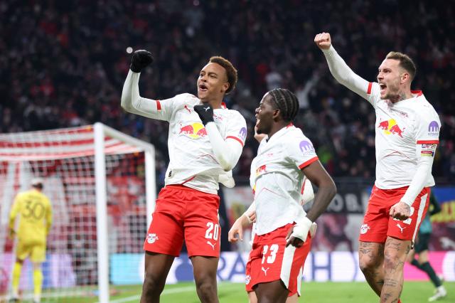 Leipzig's German midfielder #20 Assan Ouedraogo (L) celebrates scoring his team's first goal with teammates Leipzig's French defender #23 Castello Lukeba (C) and Leipzig's German defender #22 David Raum during the German first division Bundesliga football match between RB Leipzig and Werder Bremen in Leipzig on November 23, 2025. (Photo by Ronny HARTMANN / AFP) / DFL REGULATIONS PROHIBIT ANY USE OF PHOTOGRAPHS AS IMAGE SEQUENCES AND/OR QUASI-VIDEO