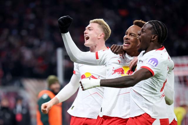 Leipzig's German midfielder #20 Assan Ouedraogo (C) celebrates scoring his team's first goal with teammates Leipzig's French defender #23 Castello Lukeba (R) and Leipzig's Danish forward #11 Conrad Harder during the German first division Bundesliga football match between RB Leipzig and Werder Bremen in Leipzig on November 23, 2025. (Photo by Ronny HARTMANN / AFP) / DFL REGULATIONS PROHIBIT ANY USE OF PHOTOGRAPHS AS IMAGE SEQUENCES AND/OR QUASI-VIDEO