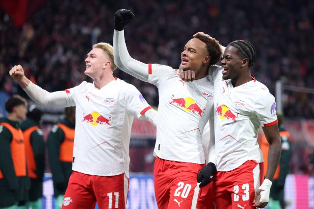 Leipzig's German midfielder #20 Assan Ouedraogo (C) celebrates scoring his team's first goal with teammates Leipzig's French defender #23 Castello Lukeba (R) and Leipzig's Danish forward #11 Conrad Harder during the German first division Bundesliga football match between RB Leipzig and Werder Bremen in Leipzig on November 23, 2025. (Photo by Ronny HARTMANN / AFP) / DFL REGULATIONS PROHIBIT ANY USE OF PHOTOGRAPHS AS IMAGE SEQUENCES AND/OR QUASI-VIDEO