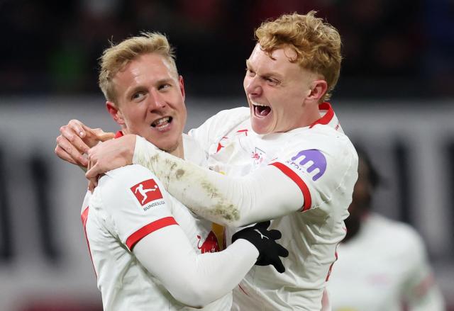 Leipzig's Austrian midfielder #24 Xaver Schlager (L) celebrates scoring his team's second goal with Leipzig's Austrian midfielder #13 Nicolas Seiwald during the German first division Bundesliga football match between RB Leipzig and Werder Bremen in Leipzig on November 23, 2025. (Photo by Ronny HARTMANN / AFP) / DFL REGULATIONS PROHIBIT ANY USE OF PHOTOGRAPHS AS IMAGE SEQUENCES AND/OR QUASI-VIDEO