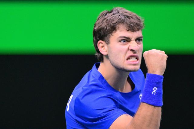 Italy's Flavio Cobolli reacts as he plays against Spain's Jaume Munar Clar during their 2025 Davis Cup men's single final tennis match at the Super Tennis Arena in Bologna, northen Italy, on November 23, 2025. (Photo by Tiziana FABI / AFP)
