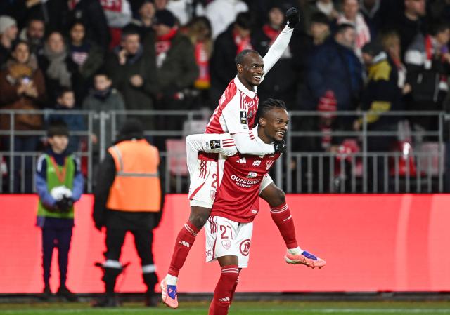 Brest's Malian midfielder #23 Kamory Doumbia (Top) celebrates with Brest's Malian defender #27 Daouda Guindo after scoring his team's second goal during the French L1 football match between Stade Brestois 29 (Brest) and FC Metz at Stade Francis-Le Ble in Brest, western France, on November 23, 2025.  (Photo by JEAN-FRANCOIS MONIER / AFP)