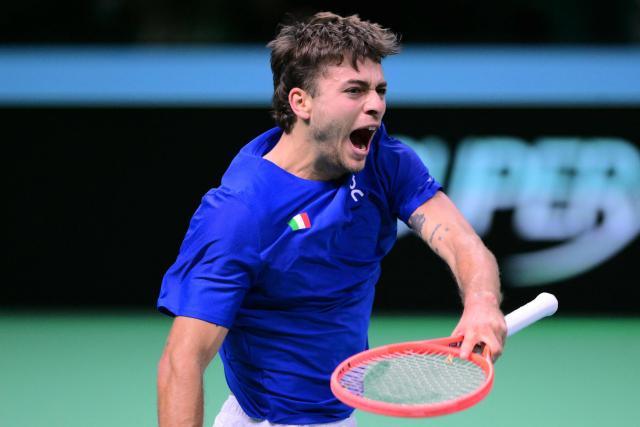 Italy's Flavio Cobolli reacts as he plays against Spain's Jaume Munar Clar during their 2025 Davis Cup men's single final tennis match at the Super Tennis Arena in Bologna, northen Italy, on November 23, 2025. (Photo by Tiziana FABI / AFP)
