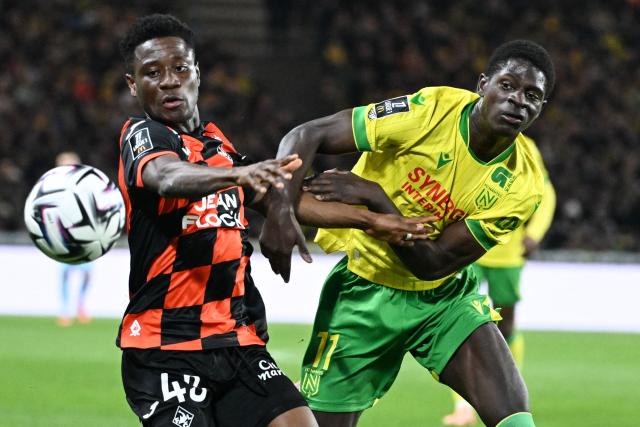 Lorient's Burkinabe defender #43 Arsene Kouassi (L) vies for the ball with Nantes' French-Guinean forward #11 Bahereba Guirassy (R) during the French L1 football match between FC Nantes and FC Lorient at the Stade de la Beaujoire–Louis-Fonteneau in Nantes, western France, on November 23, 2025. (Photo by Sebastien Salom-Gomis / AFP)