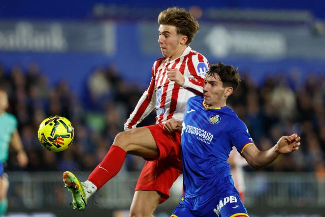 Atletico Madrid's Spanish midfielder #08 Pablo Barrios (L) fights for the ball with Getafe's Spanish midfielder #06 Mario Martin during the Spanish league football match between Getafe CF and Club Atletico de Madrid at Coliseum Alfonso Perez Stadium in Getafe on November 23, 2025. (Photo by Oscar DEL POZO / AFP)