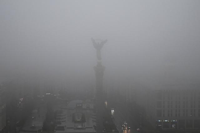 ?ars drive along Independence Square under a heavy fog, in Kyiv on November 20, 2025, amid the Russian invasion of Ukraine. (Photo by Sergei GAPON / AFP)