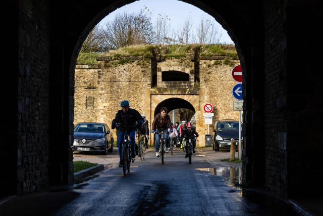 People take part in a commemorative cycling ride to pay tribute to Cindy Morvan, a 39-years-old ambassador for women's cycling who was shot dead by her ex-partner's girlfriend on October 31, 2025, in Calais, northern France, on November 11, 2025. (Photo by Sameer Al-DOUMY / AFP)