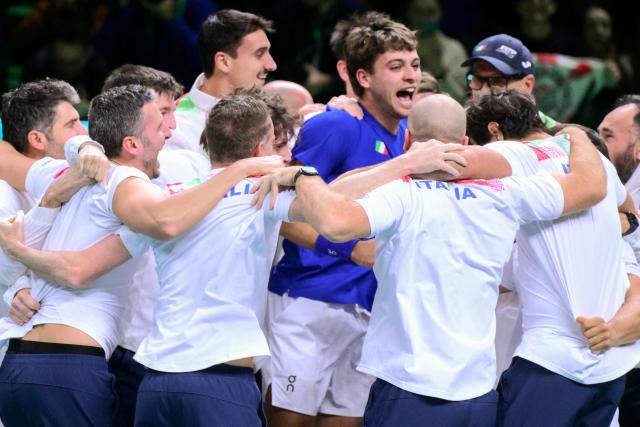 Italy's Flavio Cobolli (C) celebrates with teammates after winning over Spain's Jaume Munar Clar during their 2025 Davis Cup men's single final tennis match at the Super Tennis Arena in Bologna, northen Italy, on November 23, 2025. (Photo by Tiziana FABI / AFP)