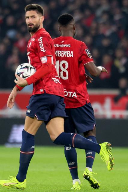 Lille's French forward #09 Olivier Giroud reacts after scoring a goal during the French L1 football match between Lille (LOSC) and Paris FC at the Stade Pierre-Mauroy in Villeneuve-d'Ascq, northern France, on November 23, 2025. (Photo by Francois LO PRESTI / AFP)