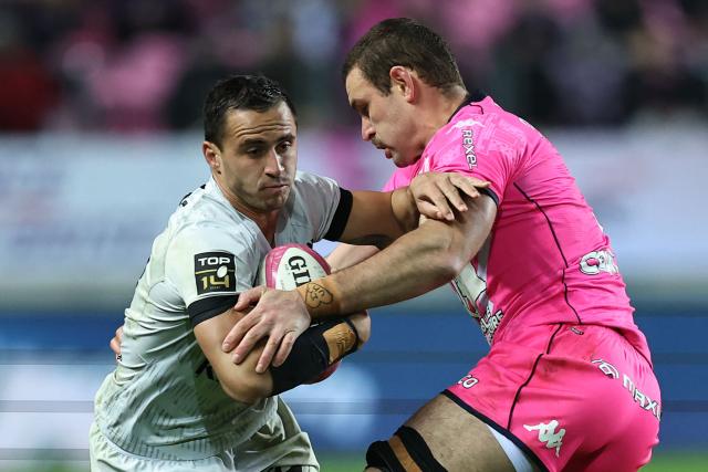 Toulon's French centre Mathieu Smaili (L) is tackled by Stade Français' French flanker Romain Briatte during the French Top14 rugby union match between Stade Francais Paris and RC Toulon at the Jean-Bouin Stadium in Paris on November 23, 2025. (Photo by Anne-Christine POUJOULAT / AFP)