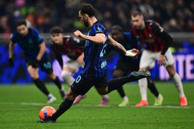 Inter Milan's Turkish midfielder #20 Hakan Calhanoglu kicks the ball to miss his penalty during the Italian Serie A football match between Inter Milan and AC Milan at San Siro stadium in Milan, northern Italy, on November 23, 2025. (Photo by Marco BERTORELLO / AFP)