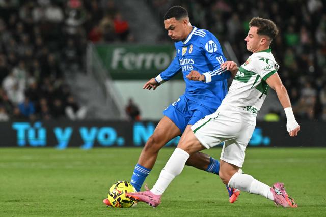 Real Madrid's English defender #12 Trent Alexander-Arnold fights for the ball with Elche's Spanish forward #11 German Valera during the Spanish league football match between Elche CF and Real Madrid CF at Martinez Valero Stadium in Elche on November 23, 2025. (Photo by JOSE JORDAN / AFP)