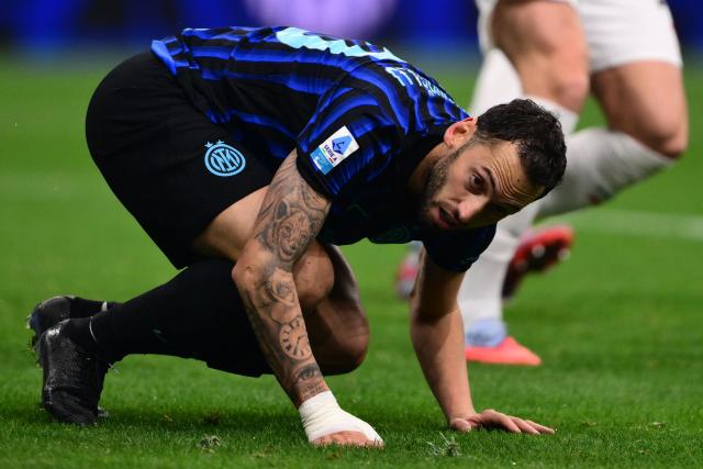 Inter Milan's Turkish midfielder #20 Hakan Calhanoglu reacts after missing his penalty kick during the Italian Serie A football match between Inter Milan and AC Milan at San Siro stadium in Milan, northern Italy, on November 23, 2025. (Photo by Marco BERTORELLO / AFP)