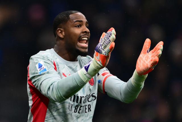 AC Milan's French goalkeeper #16 Mike Maignan reacts during the Italian Serie A football match between Inter Milan and AC Milan at San Siro stadium in Milan, northern Italy, on November 23, 2025. (Photo by Marco BERTORELLO / AFP)