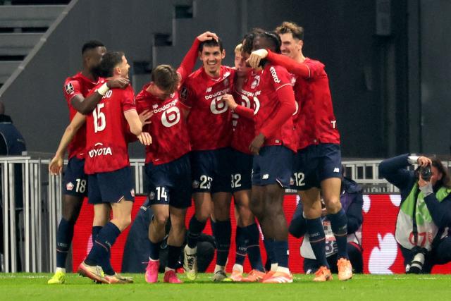 Lille's French forward #09 Olivier Giroud (L) celebrates after scoring a goal during the French L1 football match between Lille (LOSC) and Paris FC at the Stade Pierre-Mauroy in Villeneuve-d'Ascq, northern France, on November 23, 2025. (Photo by Francois LO PRESTI / AFP)
