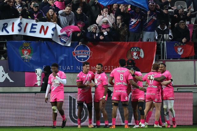Stade Francais' players celebrate a try by Stade Français' French fly-half Louis Carbonel during the French Top14 rugby union match between Stade Francais Paris and RC Toulon at the Jean-Bouin Stadium in Paris on November 23, 2025. (Photo by Anne-Christine POUJOULAT / AFP)
